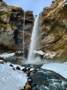 Kvernusfoss waterfall surrounded by snow