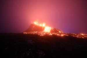Geldingadalir volcano in Iceland with a pouring lava flow in Iceland at night