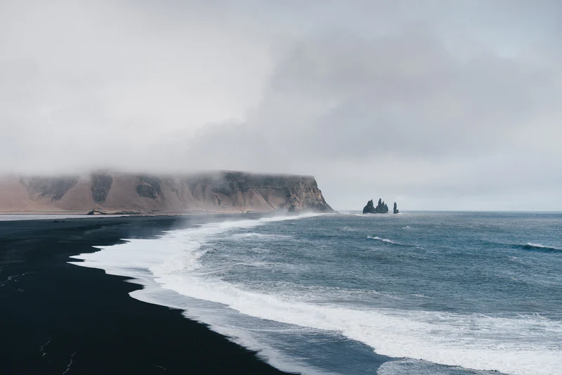 Reynisfjara black sand beach in South Iceland under an overcast sky