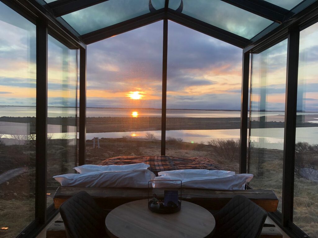 heimdall glass lodge west iceland with ocean view and sunset