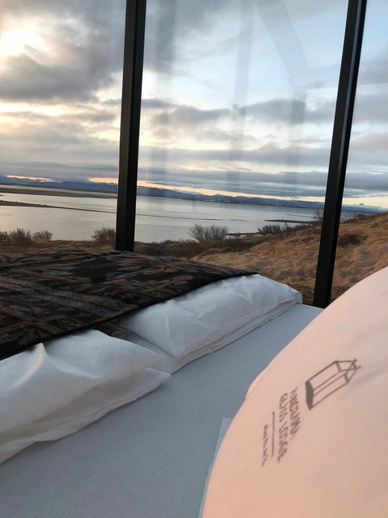Heimdall glass lodge west iceland with ocean view and sunset