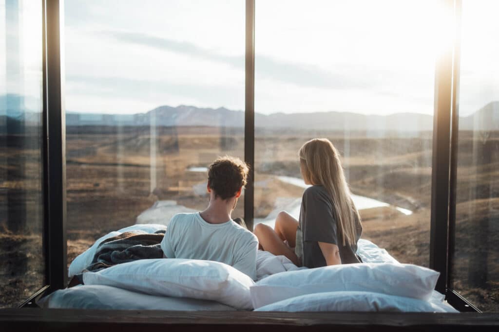 A couple enjoying New Year's Eve within the Panorama Glass Lodge